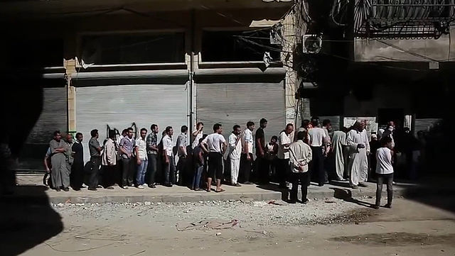 640px-Aleppians_waiting_in_a_bread_line_during_the_Syrian_civil_war