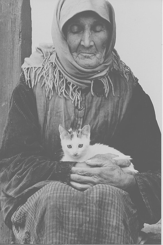 Old_woman_holding_a_cat,_Moldova_(5705717071)