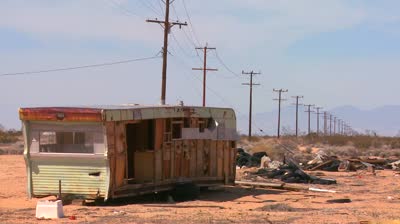 stock-footage-an-abandoned-trailer-sits-in-the-middle-of-the-mojave-desert